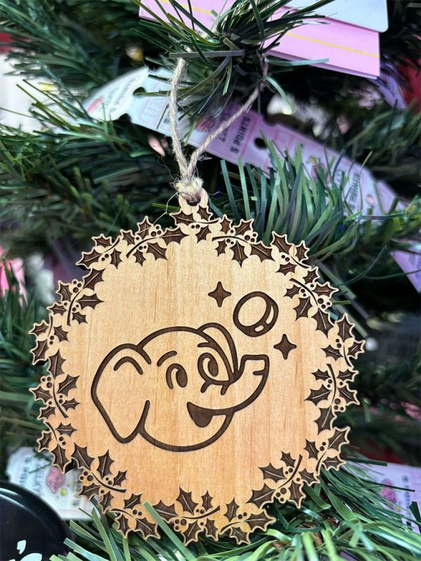 A wooden ornament with an elephant and stars.