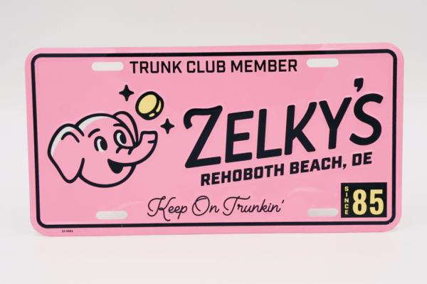 A pink license plate with a cartoon of a person holding a ball.