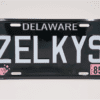 A black and white license plate with the name of zelkys