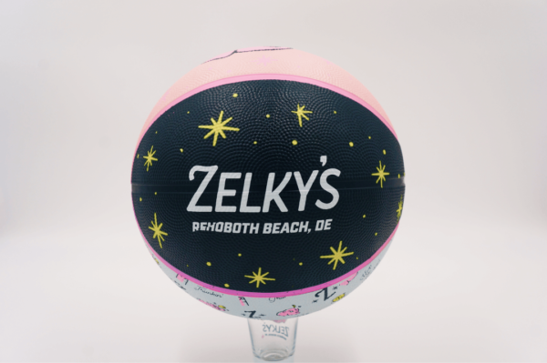 A basketball with the name of zelky 's on it.