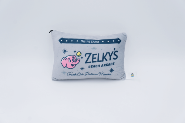 A pillow with a picture of a pink pig on it.