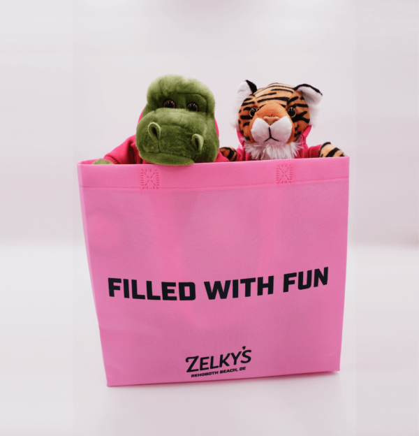 A pink bag with stuffed animals inside of it.